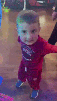 a baby in a red outfit is walking