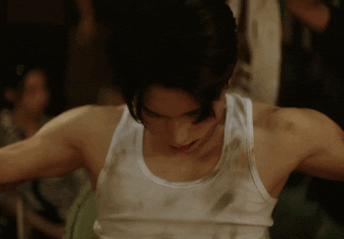 a man in a white tank top has a dirty spot on his arm