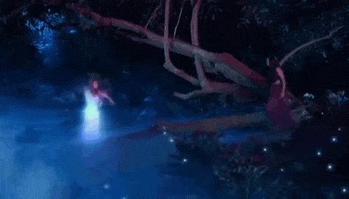 a woman in a red dress is standing next to a tree in the dark surrounded by glowing lights .