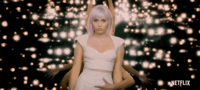 a woman with purple hair stands in front of a netflix ad