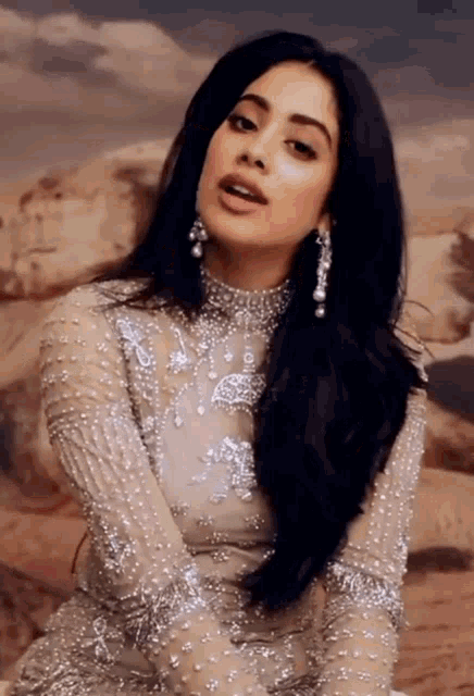 a woman with long black hair is wearing a very fancy dress
