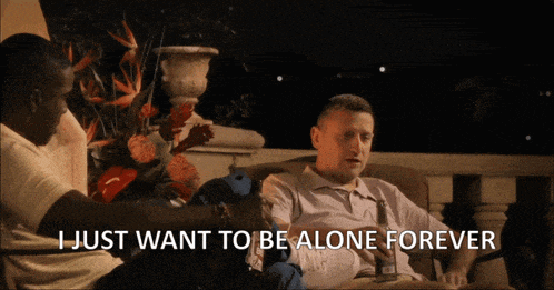 a man sitting on a couch with the words i just want to be alone forever
