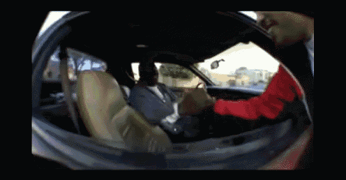 a man in a suit is sitting in a car with another man