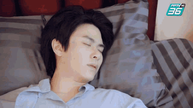 a man is sleeping on a bed with a pptv logo in the background