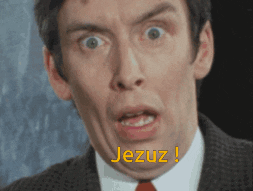 a man in a suit and tie is making a funny face and the word jeruz is on the bottom of his face