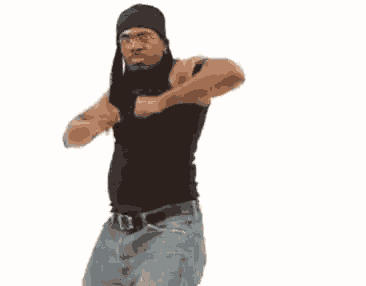 a man in a black tank top and jeans is dancing .