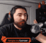 a man with a beard is wearing headphones and a t-shirt that says ' tongia.com '