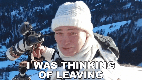 a woman holding a camera with the words " i was thinking of leaving " behind her