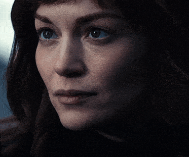 a close up of a woman 's face with a tear running down her cheek