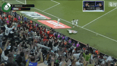 a crowd of people watching a soccer game with a scoreboard that says endrick