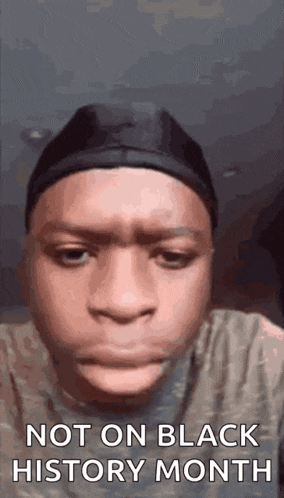 a young man is making a funny face while wearing a hat and a headband .