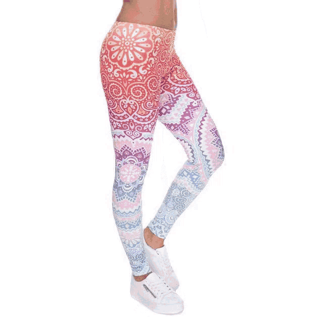 a woman is wearing a pair of blue leggings with a palm tree print