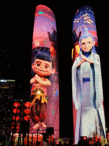 two tall buildings with cartoon characters projected on them
