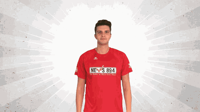 a man in a red shirt that says news 894 on it