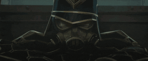 a man in a gas mask is holding a knife in front of his face