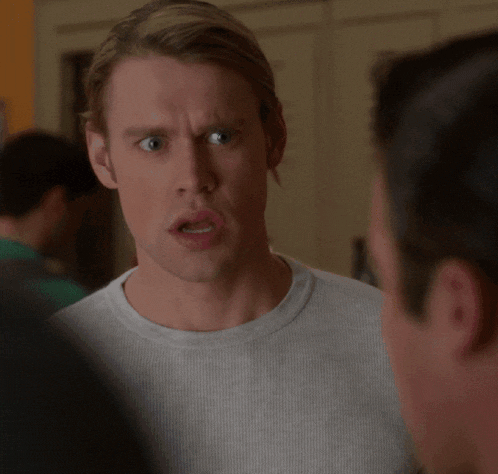a man with a surprised look on his face looks at another man