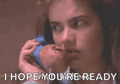 a woman is talking on a cell phone with a baby in her arms .