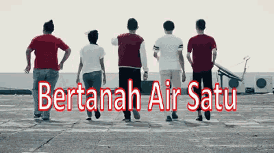 a group of people walking in a line with the words bertanah air satu above them