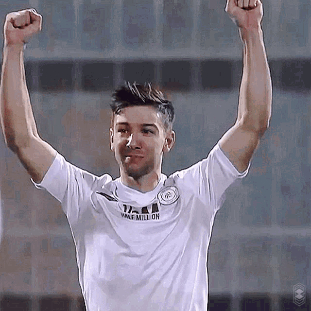 a man in a white shirt with half million on it