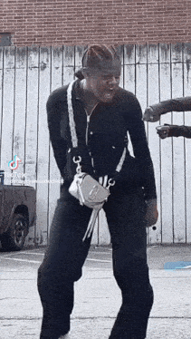 a tiktok video of a person dancing with a purse