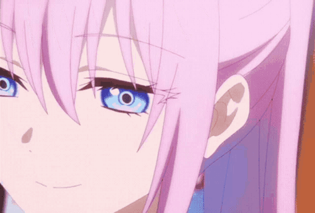 a close up of a girl 's face with blue eyes