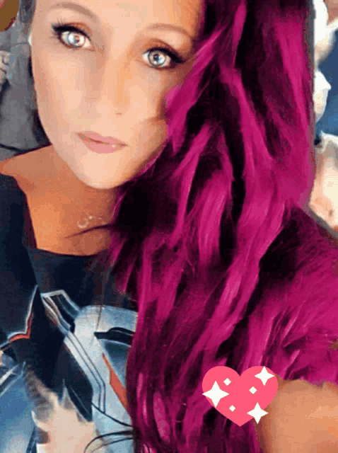 a woman with purple hair has a heart sticker on her arm