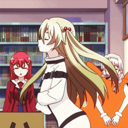 a girl with long blonde hair stands in front of a bookcase