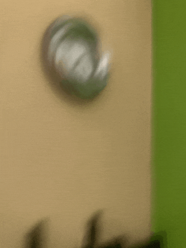 a blurred image of a clock on a wall .