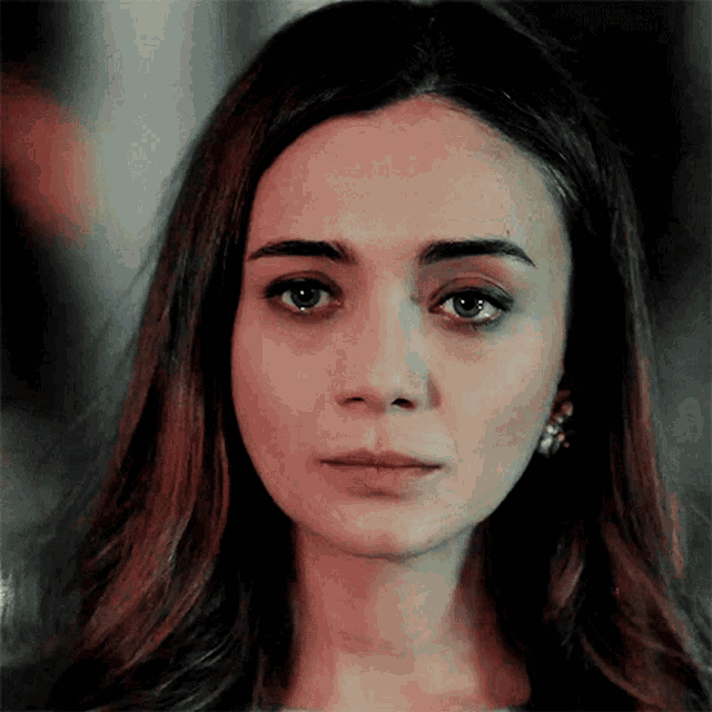 a woman with a serious look on her face