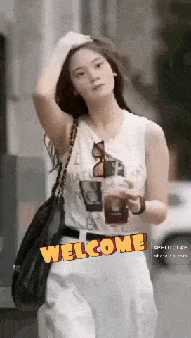 a woman in a white tank top is holding a cup of coffee and the word welcome is on the bottom right