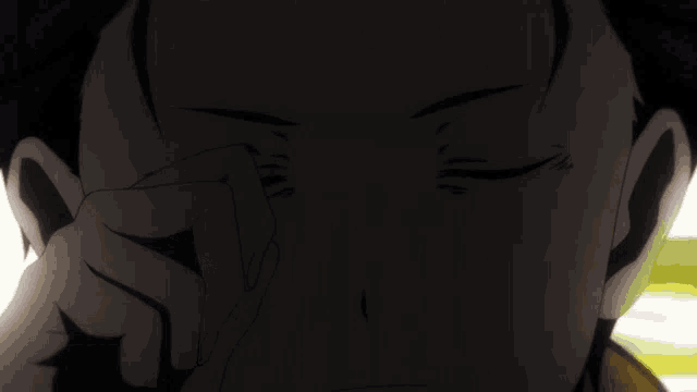 a close up of a person 's face with a hand on it