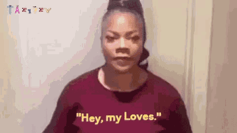 a woman in a purple shirt is saying " hey , my loves . "