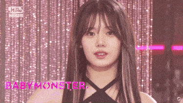 a close up of a woman 's face with the words babymonster in pink