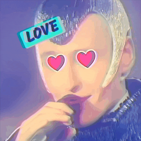 a man with hearts in his eyes has a sticker that says love on his head