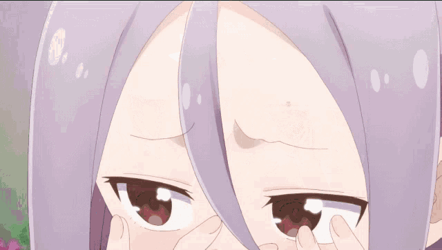 a close up of a girl with purple hair covering her face