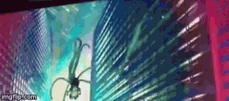a spider is hanging from a building in front of a city skyline .