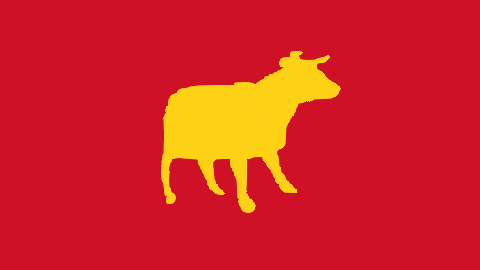 a yellow silhouette of a cow against a red background