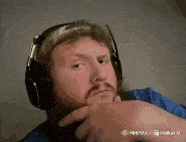 a man with a beard wearing headphones and a hat
