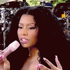 a woman with long black hair is holding a microphone