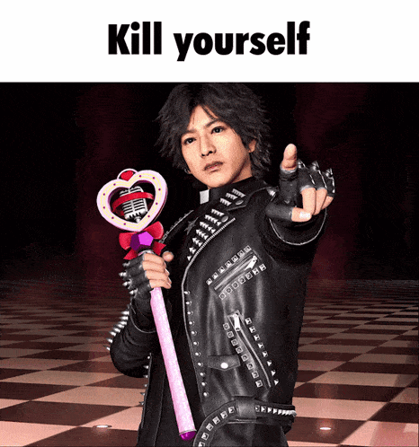 a man in a leather jacket is holding a microphone and pointing at the camera with the words " kill yourself " above him