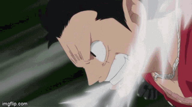 a close up of a person 's face with a smoke coming out of his mouth .