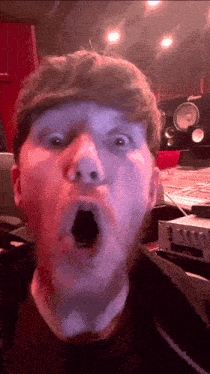 a close up of a man 's face with a surprised look on his face