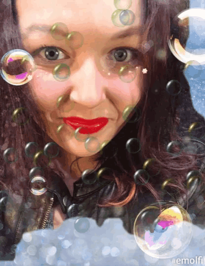 a woman with red lips is surrounded by soap bubbles and the hashtag #emolii