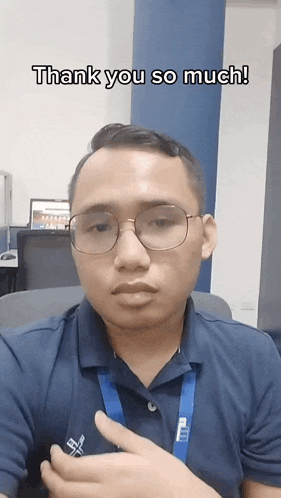 a man wearing glasses and a blue shirt says " thank you so much "