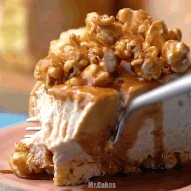 a slice of cheesecake with caramel sauce and popcorn is being eaten by a fork