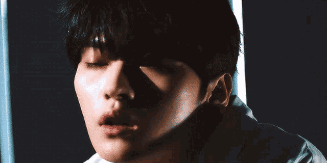 a close up of a person 's face with their mouth open