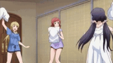 a group of anime girls are having a pillow fight in a room .