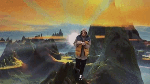 a man is standing on top of a mountain looking at his cell phone