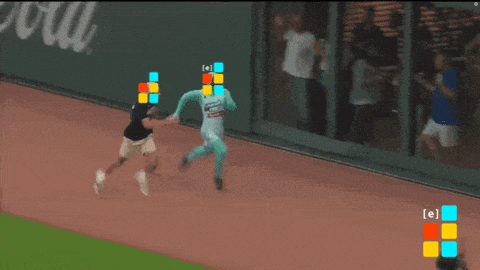 a man in a microsoft costume is running on a track with other people