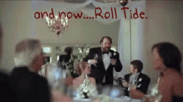 a man in a tuxedo is giving a speech at a wedding reception with the words and now roll tide behind him